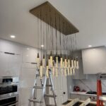 heavy chandelier installation above kitchen island in alpharetta, ga 1